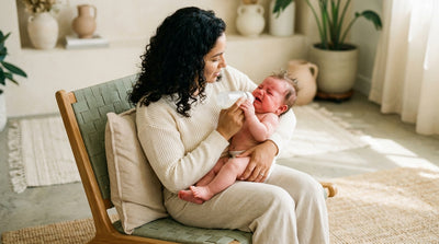 A mother patiently feeding her unsettled baby in a propped-up position, the baby's head higher than their stomach